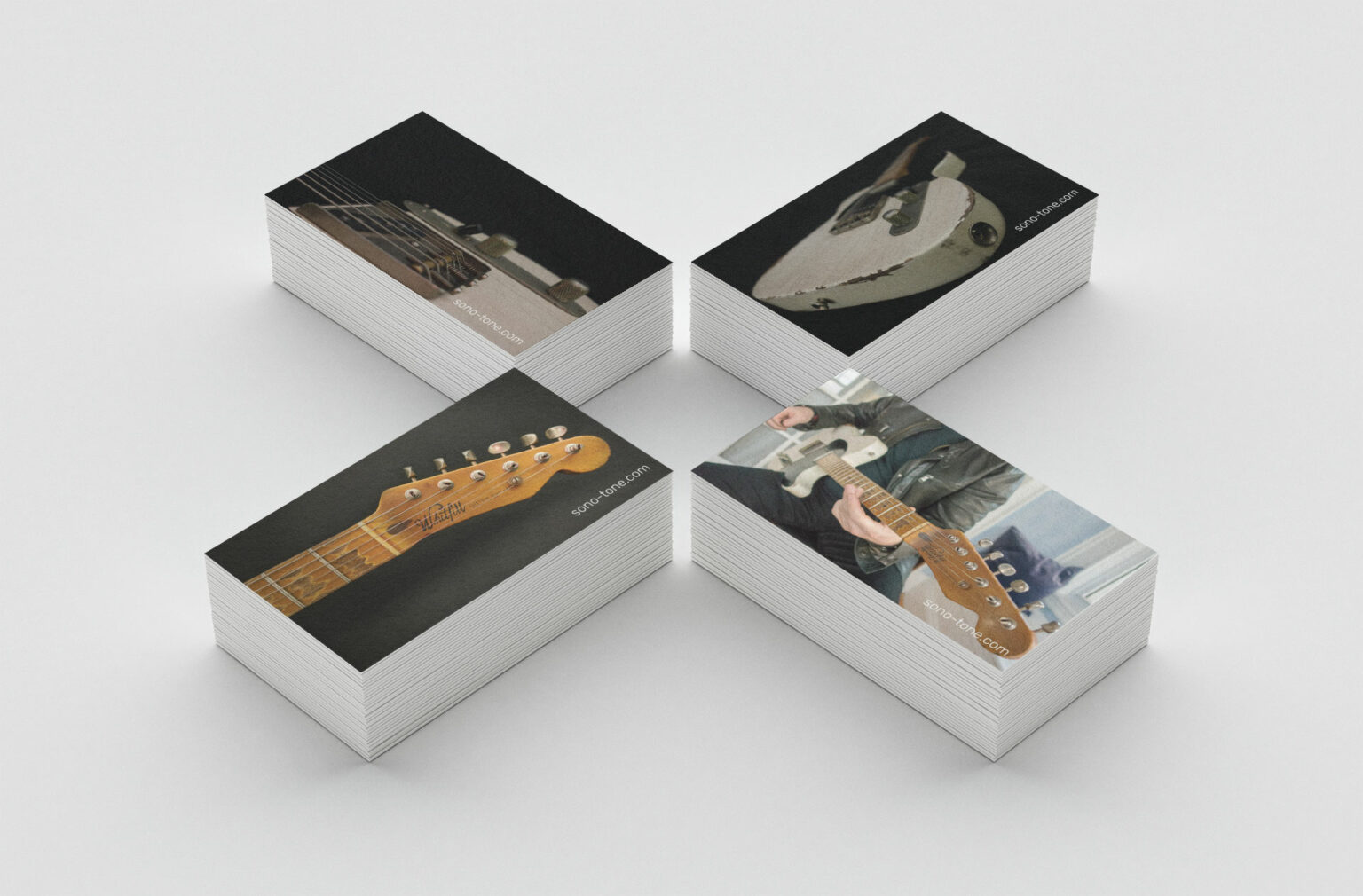 Reverse of the SonoTone business card carrying guitar and guitar-player imagery behind the logo and contact details.