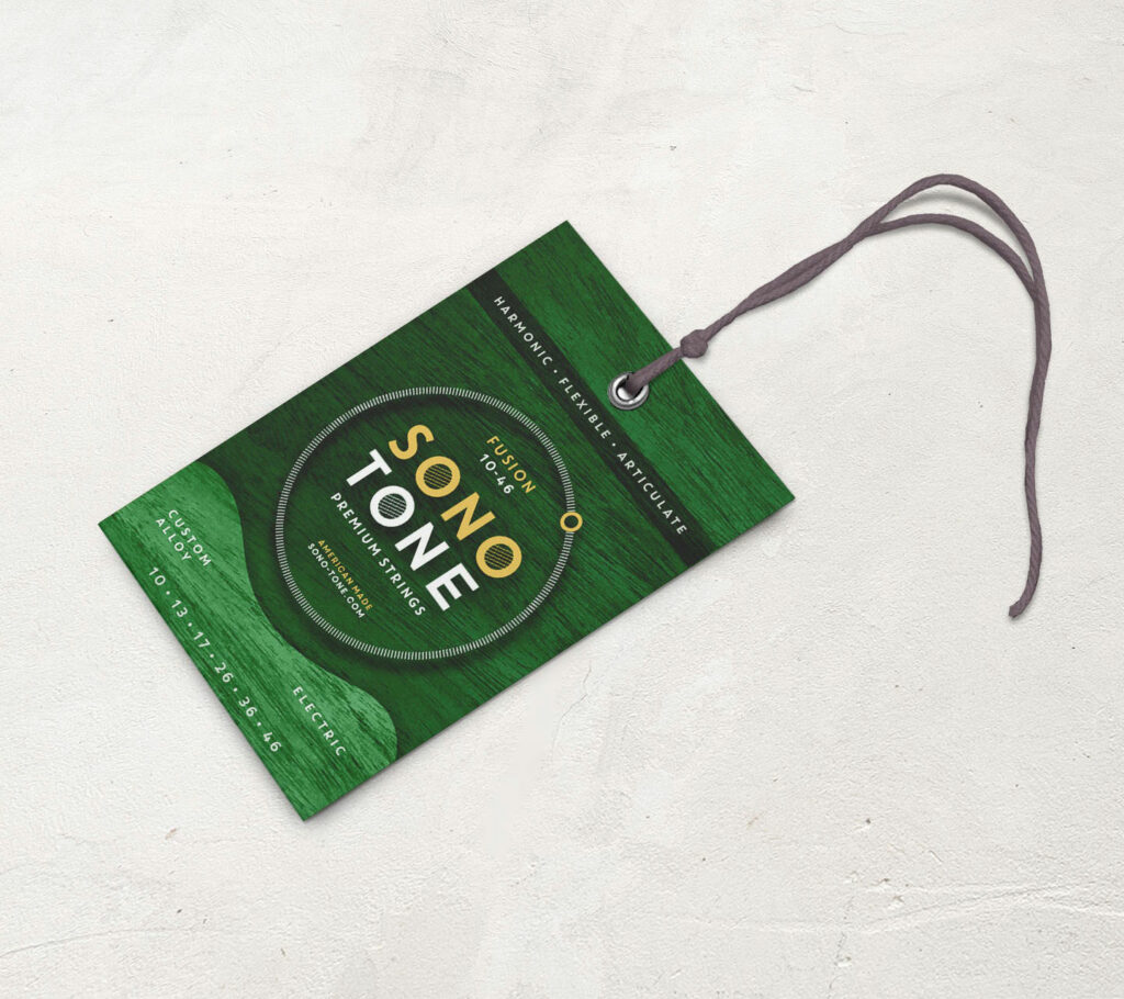 SonoTone Fusion hang tag in the green colorway, marking shop-floor guitars strung with Fusion electric strings.