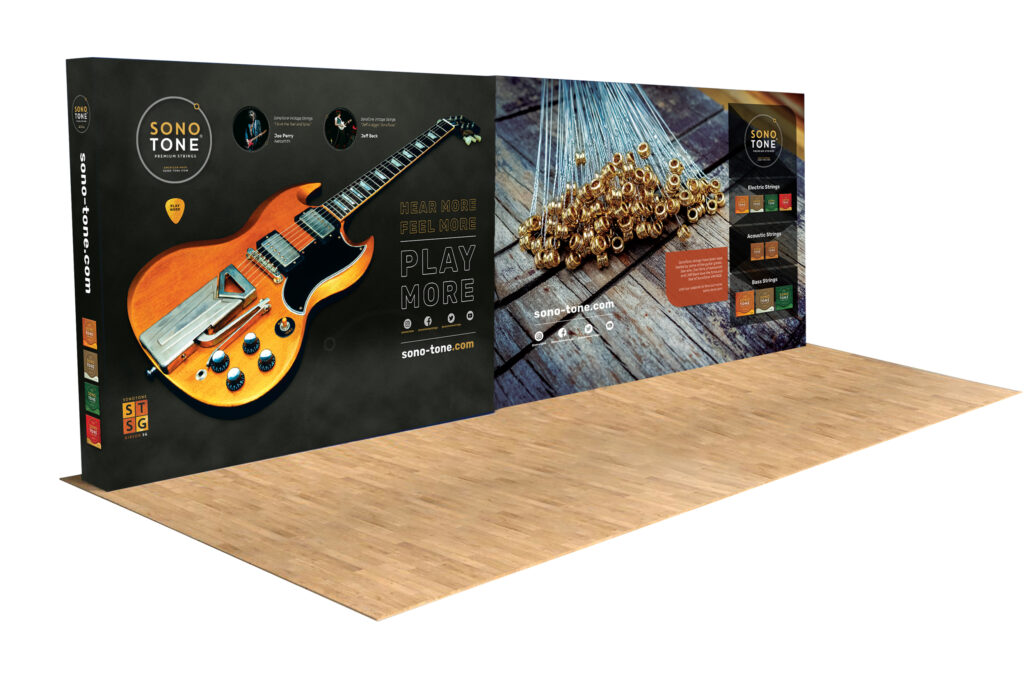 SonoTone exhibit booth presenting guitars, strings, and brand imagery within the lightweight modular panel system.