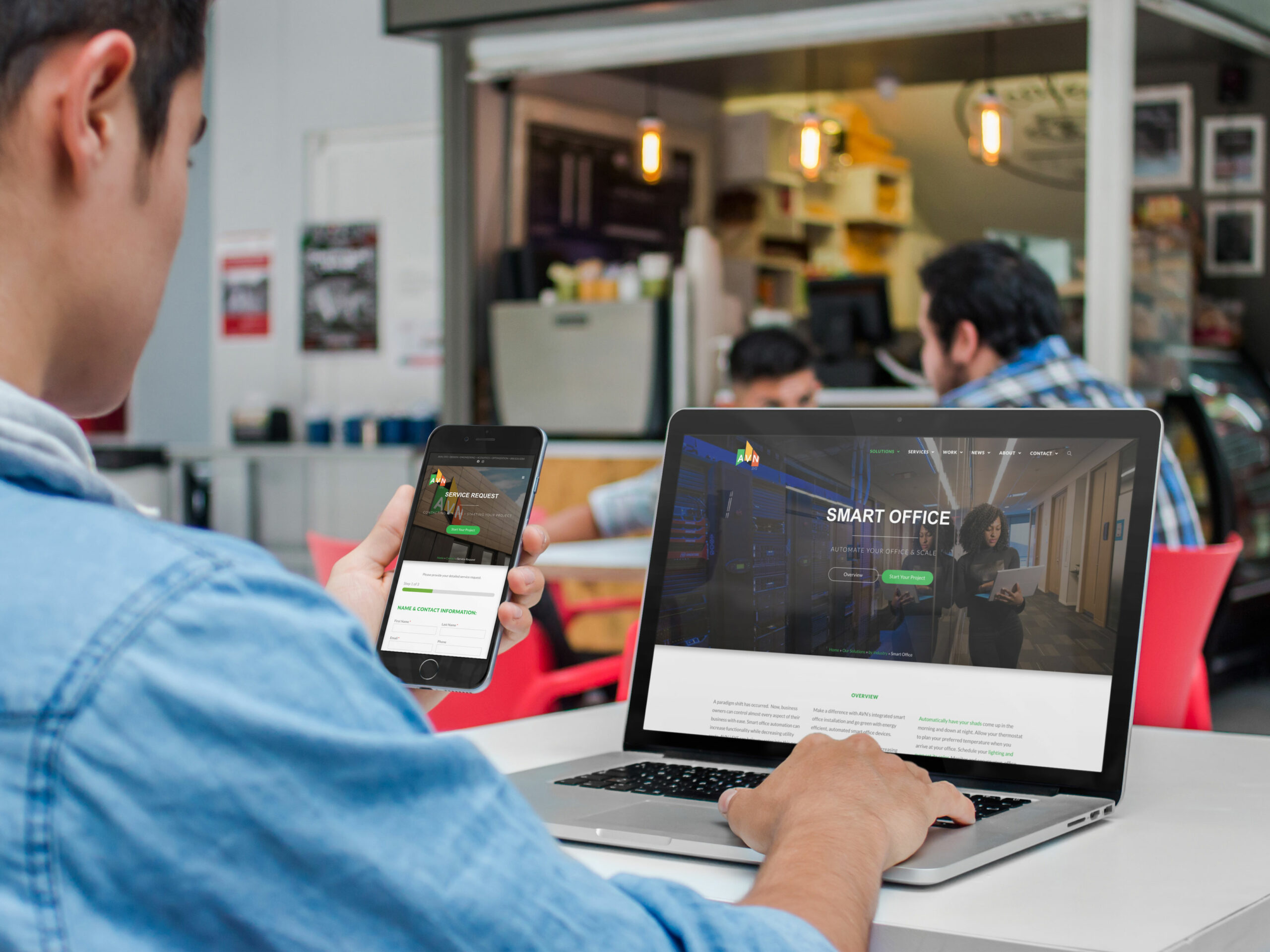 Laptop and phone in a cafe showing the Smart Office solution page and a mobile service request form side by side.
