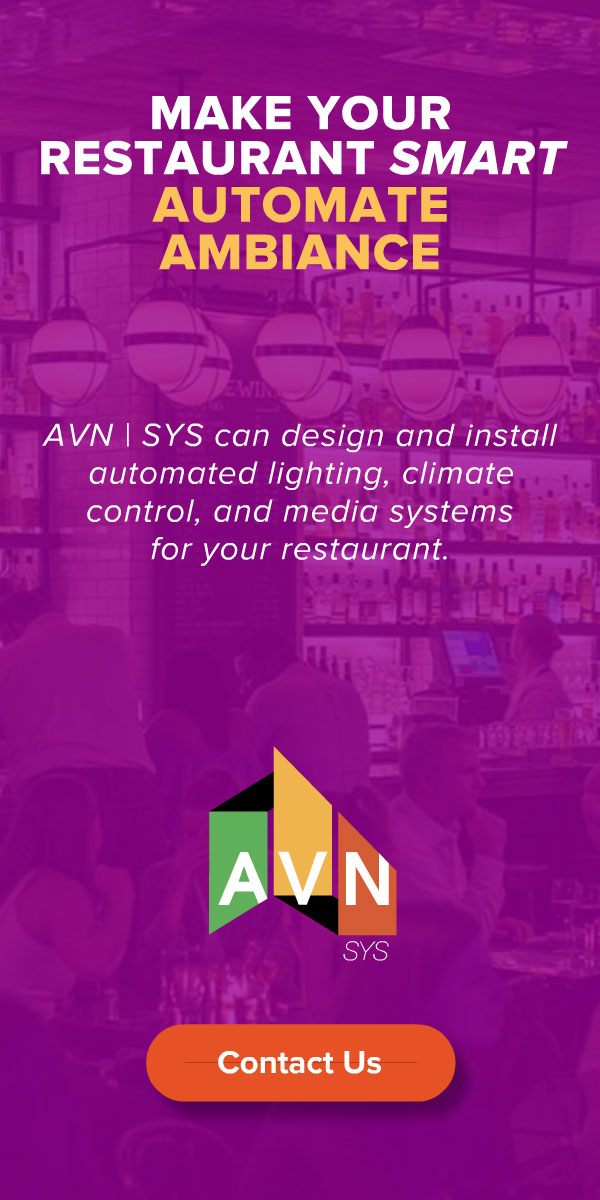 AVN | SYS restaurant display ad, 'Make Your Restaurant Smart — Automate Ambiance,' promoting automated lighting, climate control, and media systems, on a purple bar-interior backdrop with the AVN logo.