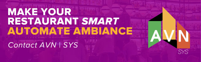 AVN | SYS restaurant display ad, 'Make Your Restaurant Smart — Automate Ambiance,' promoting automated lighting, climate control, and media systems, on a purple bar-interior backdrop with the AVN logo.