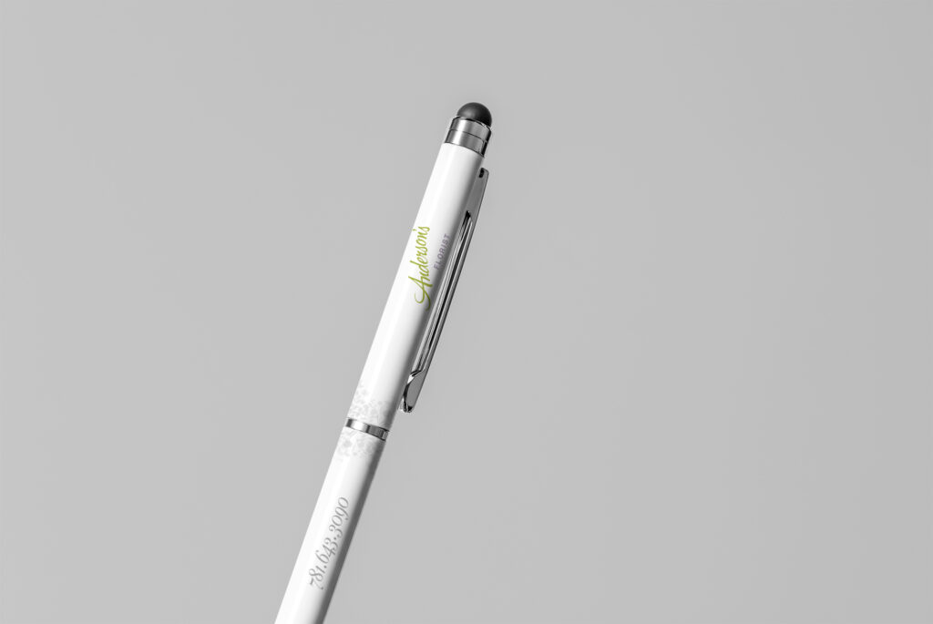 White stylus pen printed with the green script mark and phone number along the barrel, a small marketing giveaway piece.