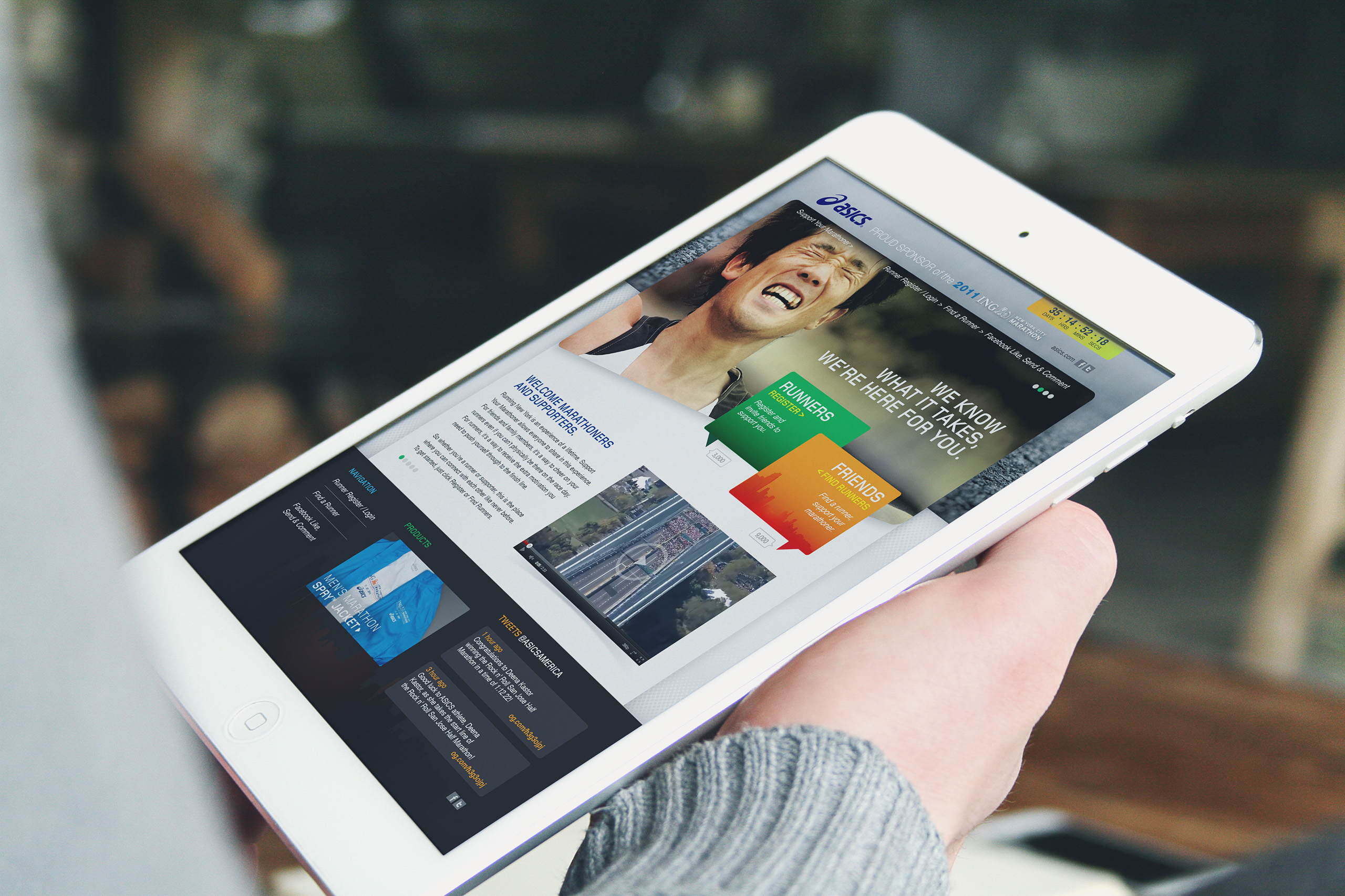 Hand-held tablet showing the welcome page for marathoners and supporters, runner hero above course video and colored role panels.