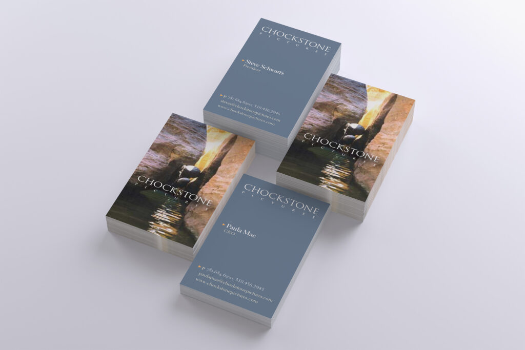 Four stacks of Chockstone Pictures cards pairing slate-blue contact fronts with canyon photography of a wedged chockstone glowing in sunlight.