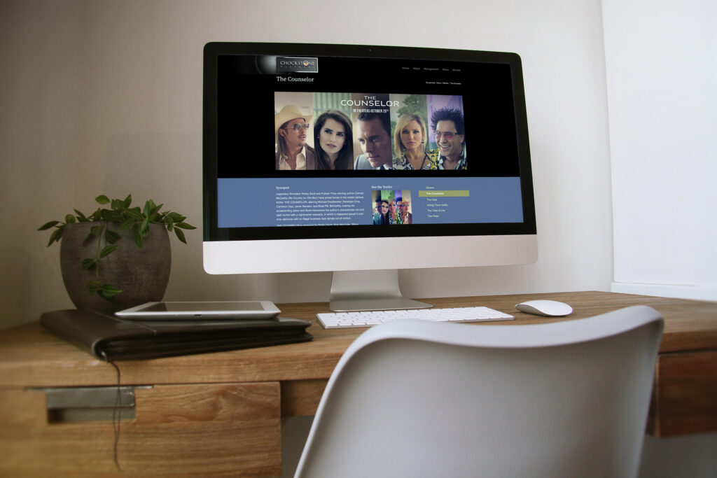 The Counselor film page on an iMac, the cast banner above synopsis, trailer stills, and reviews framed by the film’s own artwork.