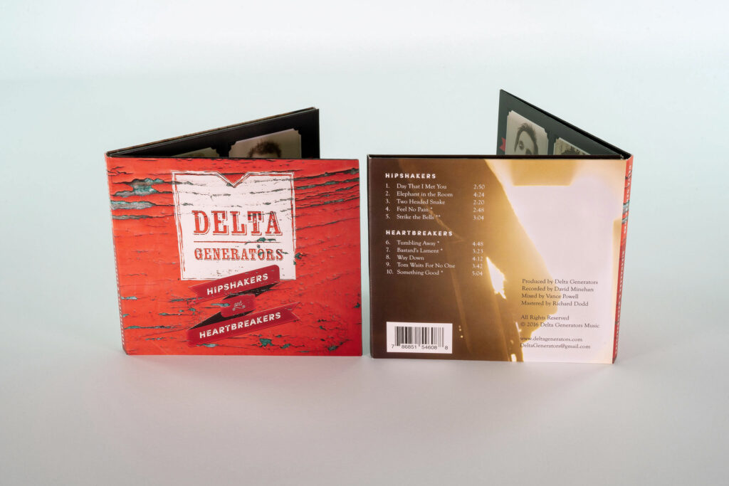 Front and back covers standing side by side, the red distressed logo facing a warm tracklist panel with barcode and credits.