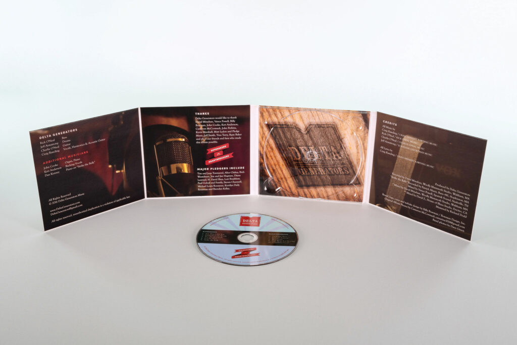 Opened gatefold panels standing behind the loose disc, its label carrying the red band mark over a light-blue sunburst.