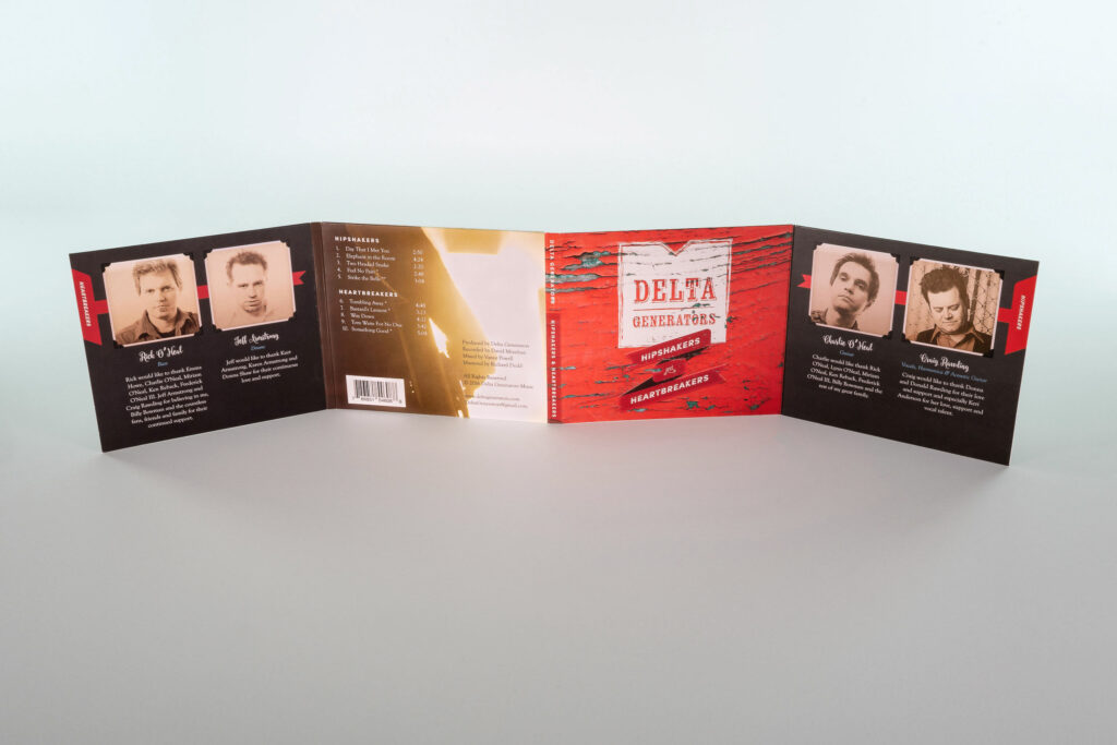Six-panel digipak fully unfolded, sepia member portraits and red ribbon banners flanking the chipped-paint cover at the center.