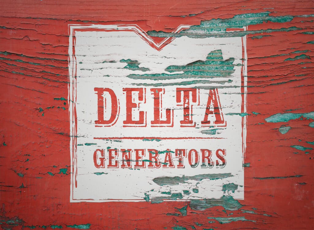 White logo panel screen-printed across weathered red barn boards, with chipped paint revealing teal undercoat around the distressed Delta Generators lettering.