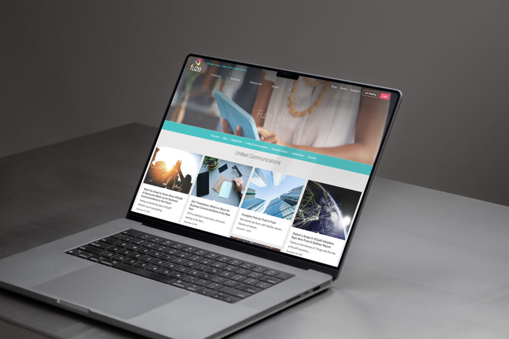 Fuze blog on a MacBook, Unified Communications posts arranged as cards beneath the teal topic navigation.