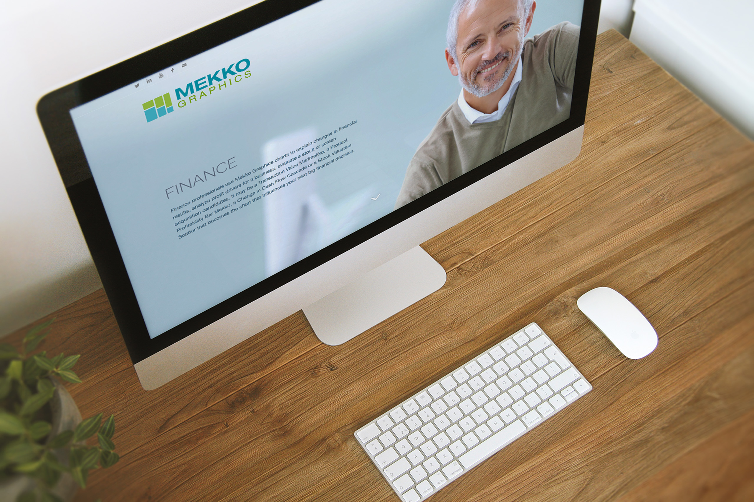 Desktop monitor viewed from above showing the Finance segment page, a smiling professional in the hero beside the logo.