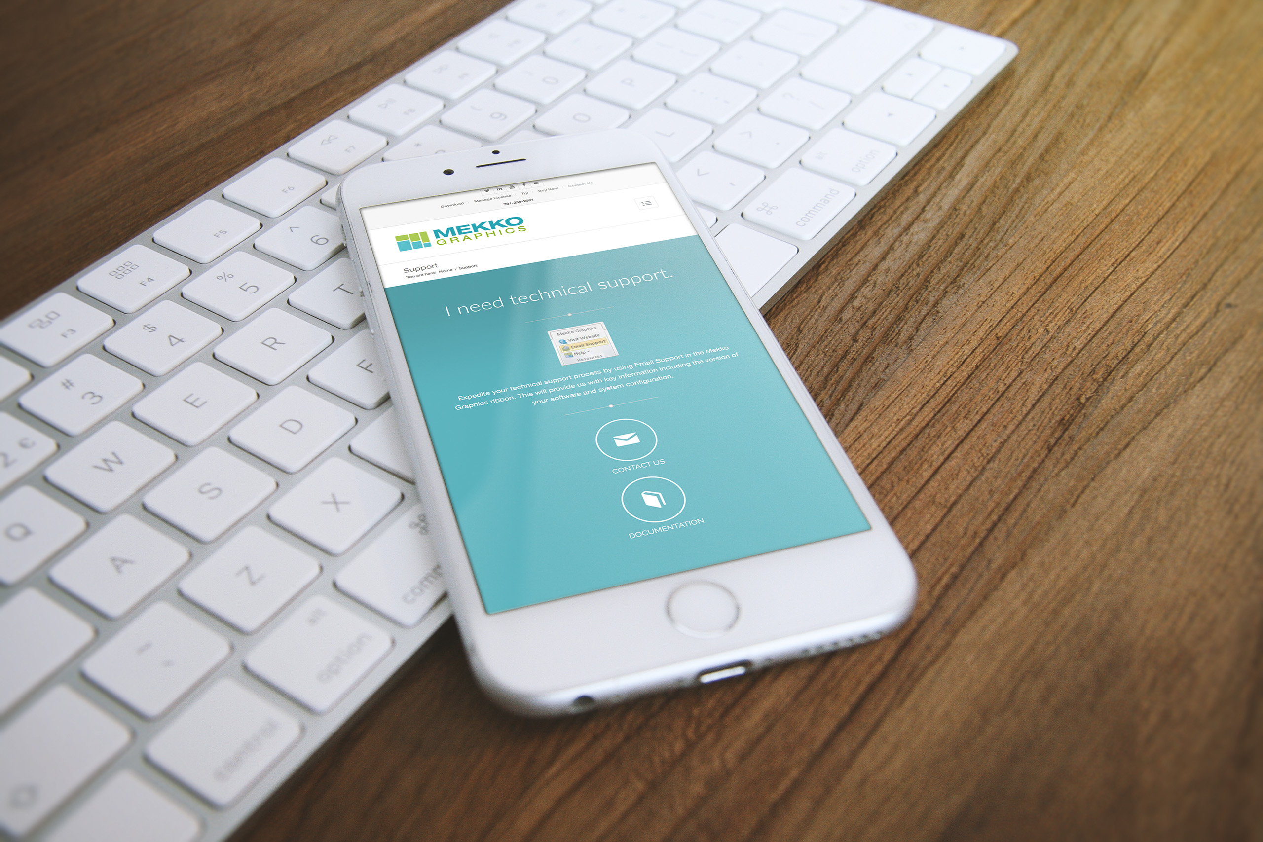 Phone resting on a white keyboard showing the teal technical support page with contact and documentation options beneath the logo.