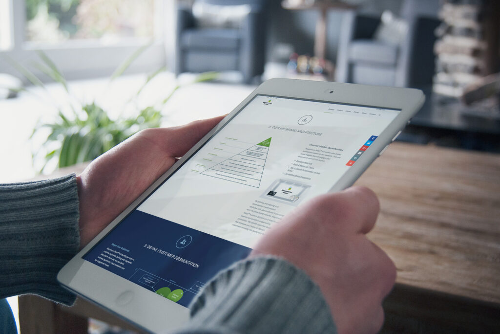Methodology page on an iPad mini, the brand architecture pyramid above the customer segmentation step in navy.