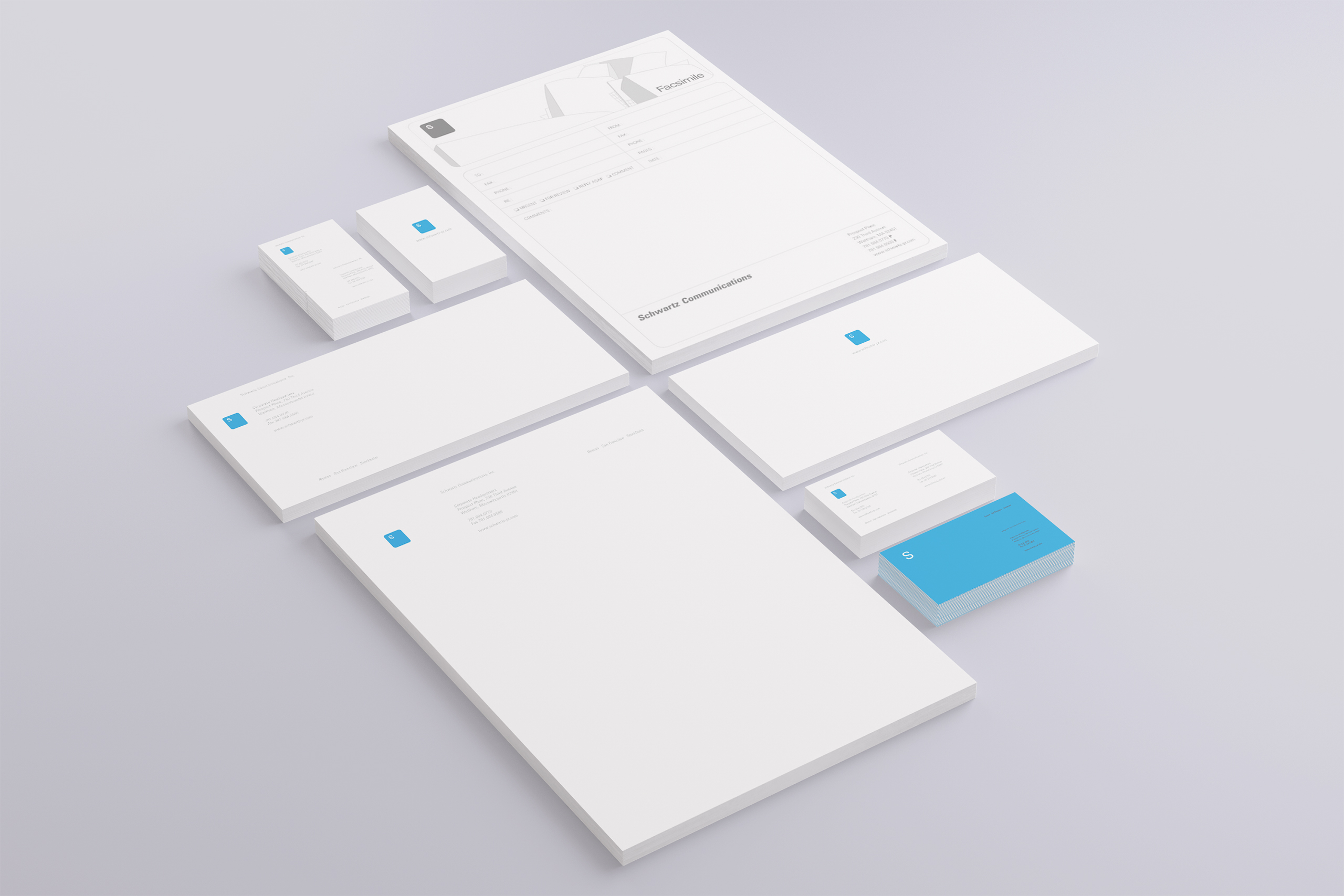 Full stationery suite in white with the blue square mark: letterhead, fax sheet, envelopes, and blue-edged business card stacks.