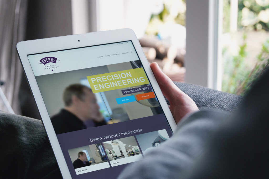 SPI homepage on an iPad, the Precision Engineering, pinpoint profitability hero above Who We Are and The Lab panels.