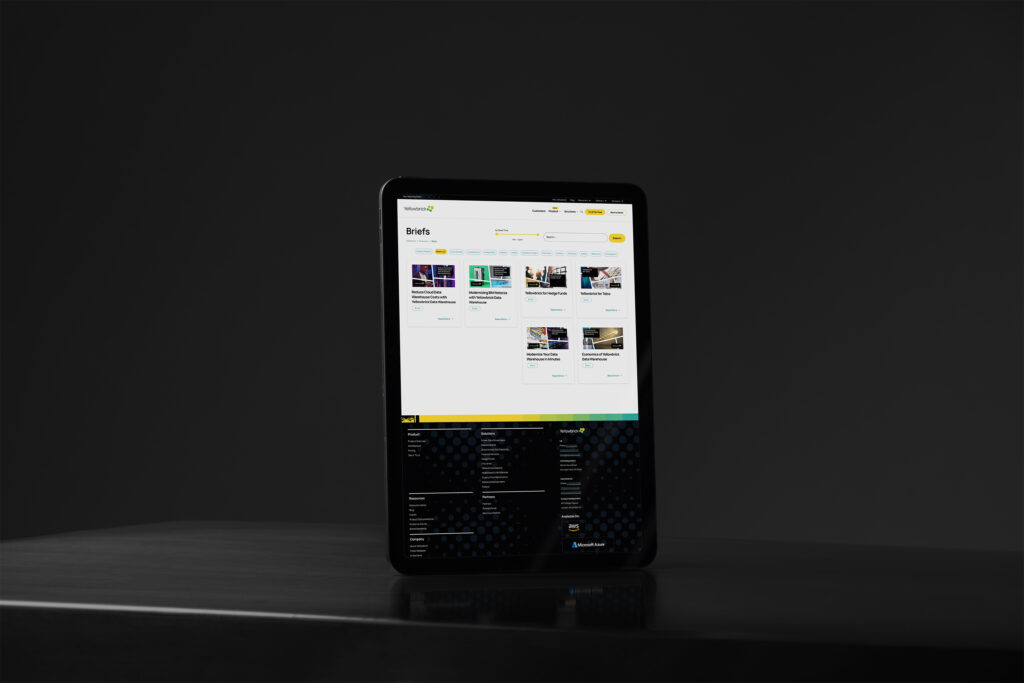 Tablet standing in low light showing the Briefs index above the dark halftone footer with the yellow diagonal divider.