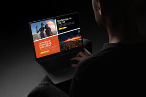 Man on a couch reads the Modernize to the Hilt page, the alien duo photo beside a Leverage a Distributed Data Cloud panel.