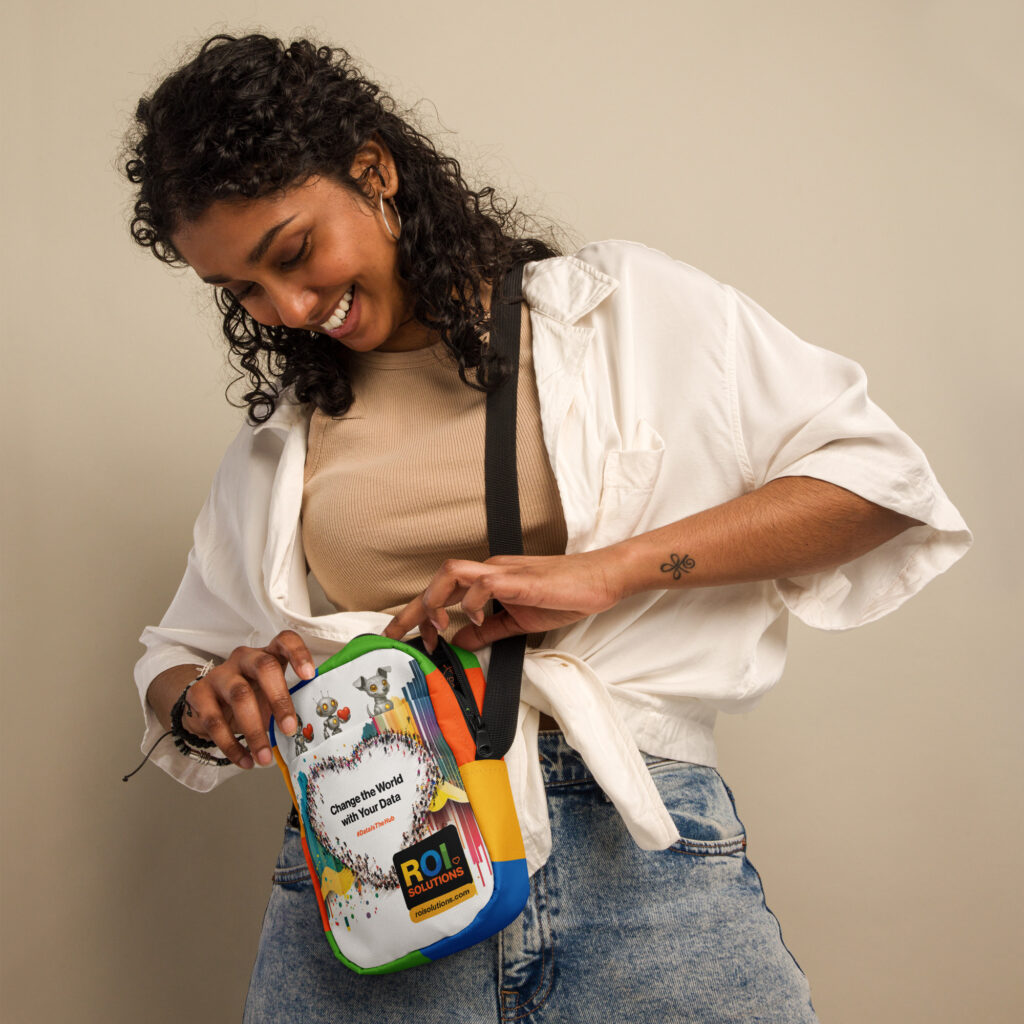 Smiling model in denim opens the white utility crossbody printed with characters and the crowd heart.