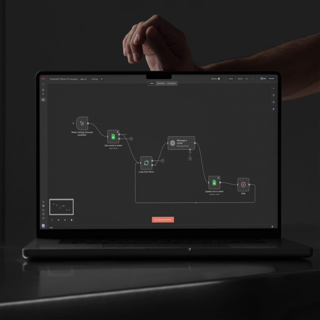 Laptop showing the n8n agentic workflow, nodes looping from sheet rows through the model and back to updates.