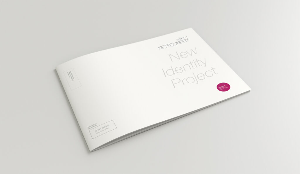 White New Identity Project cover with embossed lettering and a single magenta approval dot on the landscape standards book.