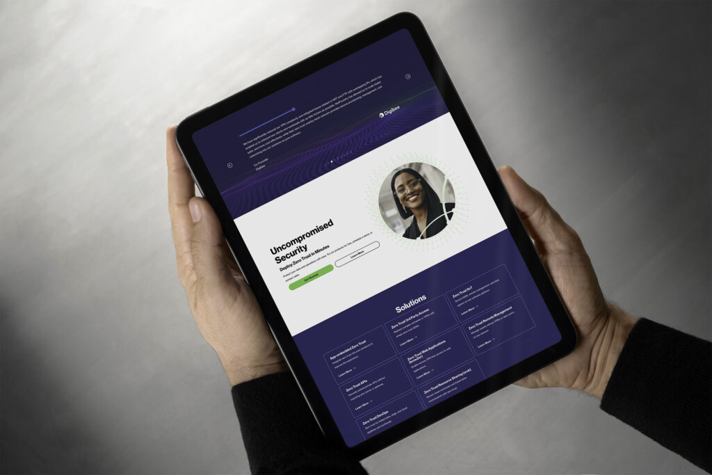 Hands hold a tablet showing the Uncompromised Security page, a portrait circle above the purple solutions grid.