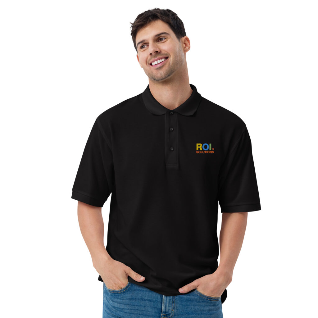 Smiling model in the black pique polo shirt, the embroidered multicolor logo on the chest over jeans.