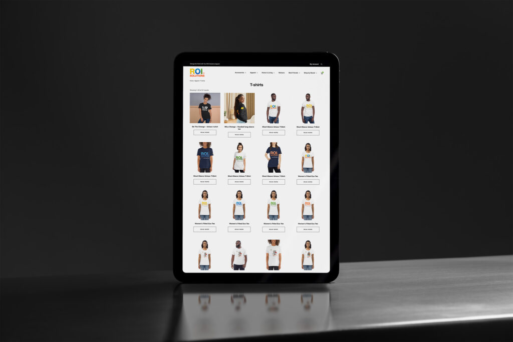 Tablet standing on steel showing the t-shirts category grid, tees and tanks across four columns.