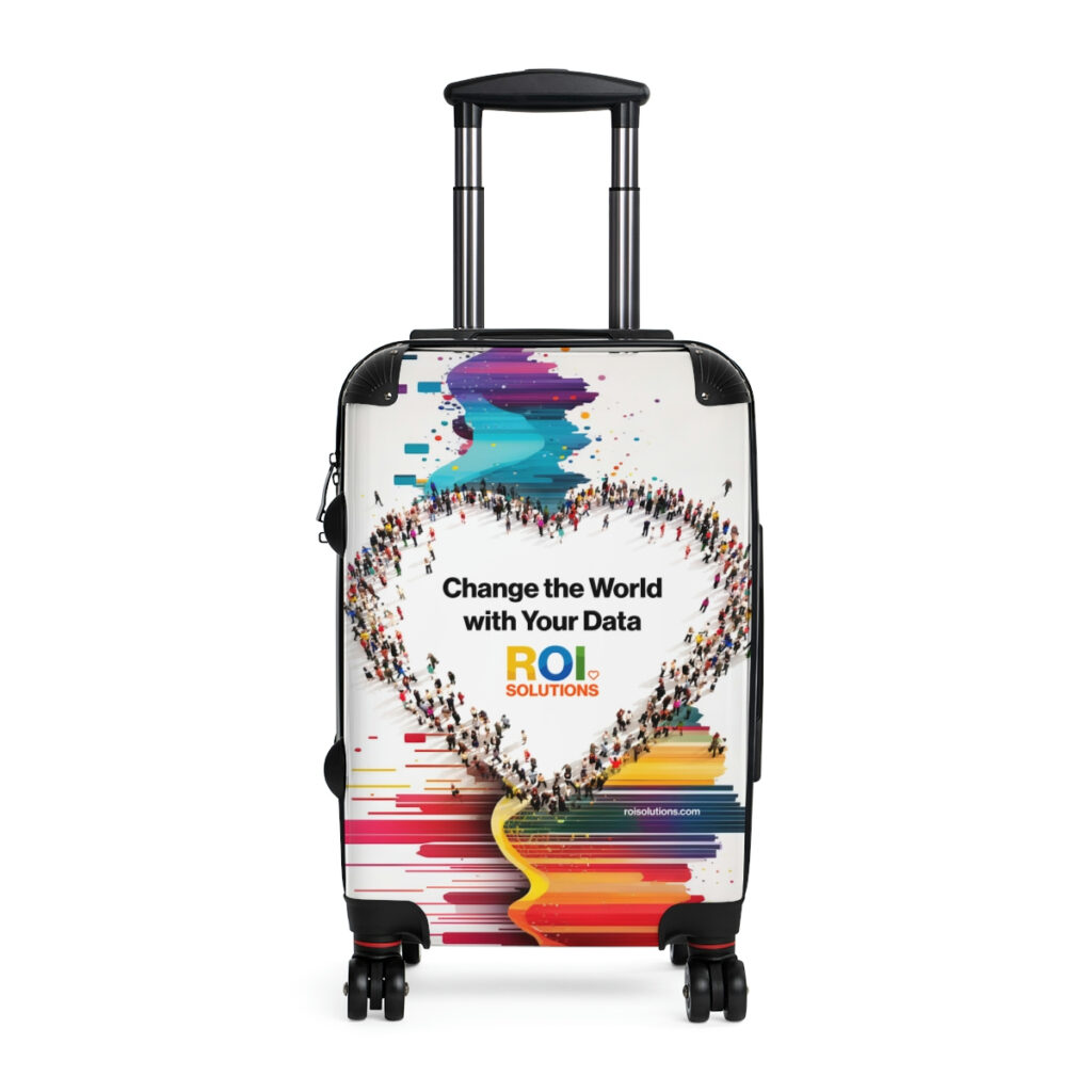 White carry-on spinner wrapped with the crowd heart and brand promise over rainbow paint streaks.