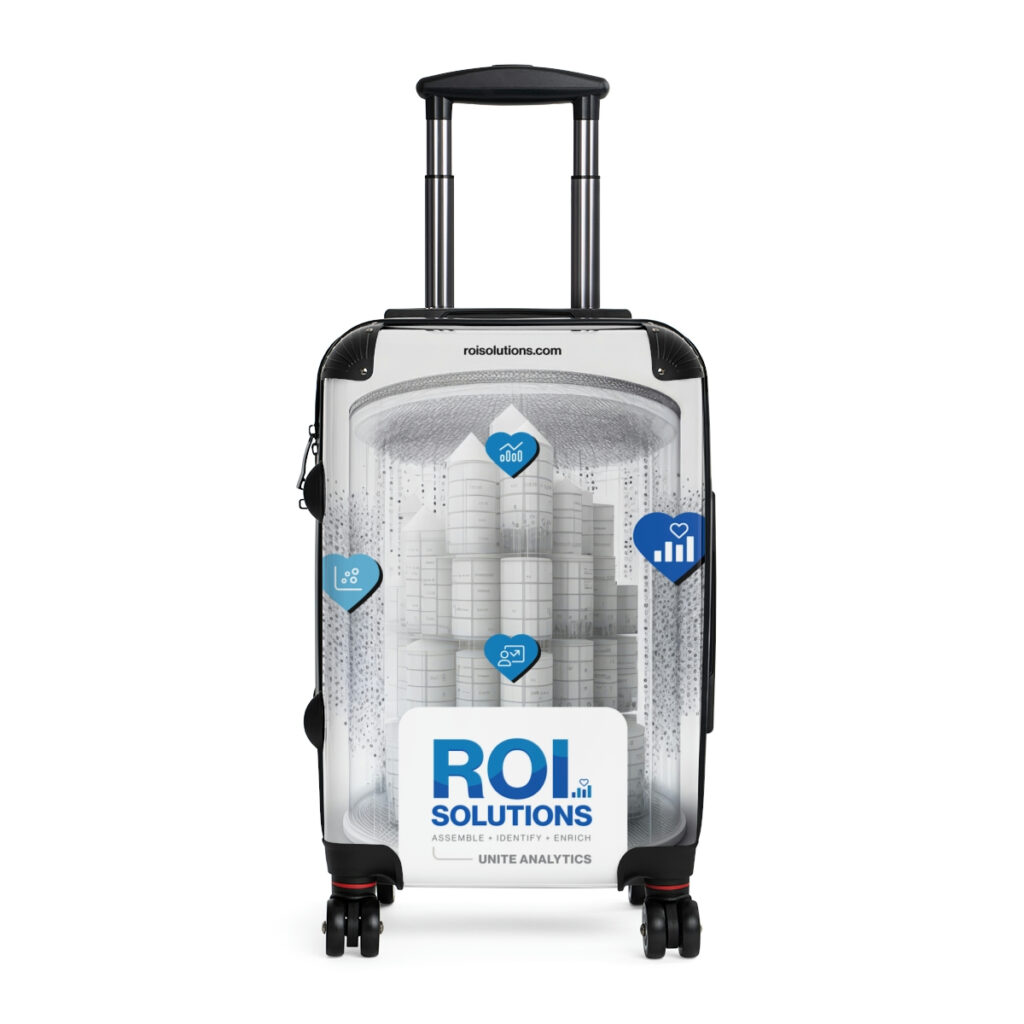 White carry-on spinner wrapped in the Unite Analytics identity, the domed data city between blue heart icons.