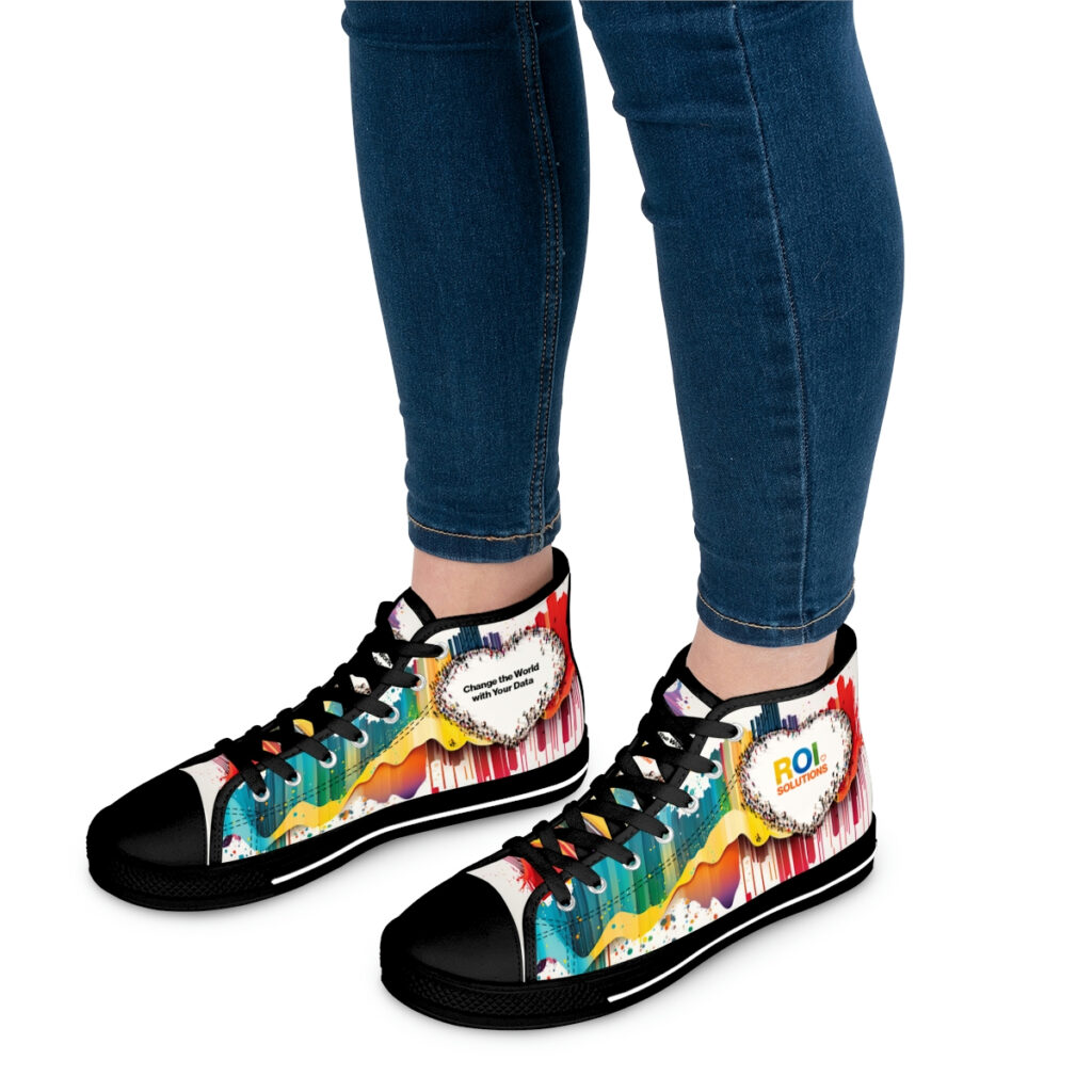 Model in rolled blue jeans wears the black-soled crowd-heart high-tops, the rainbow prints wrapping both shoes.