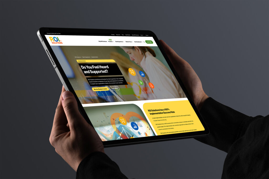 Hands hold a tablet showing the implementation page, Do You Feel Heard and Supported above the one hundred percent success panel.