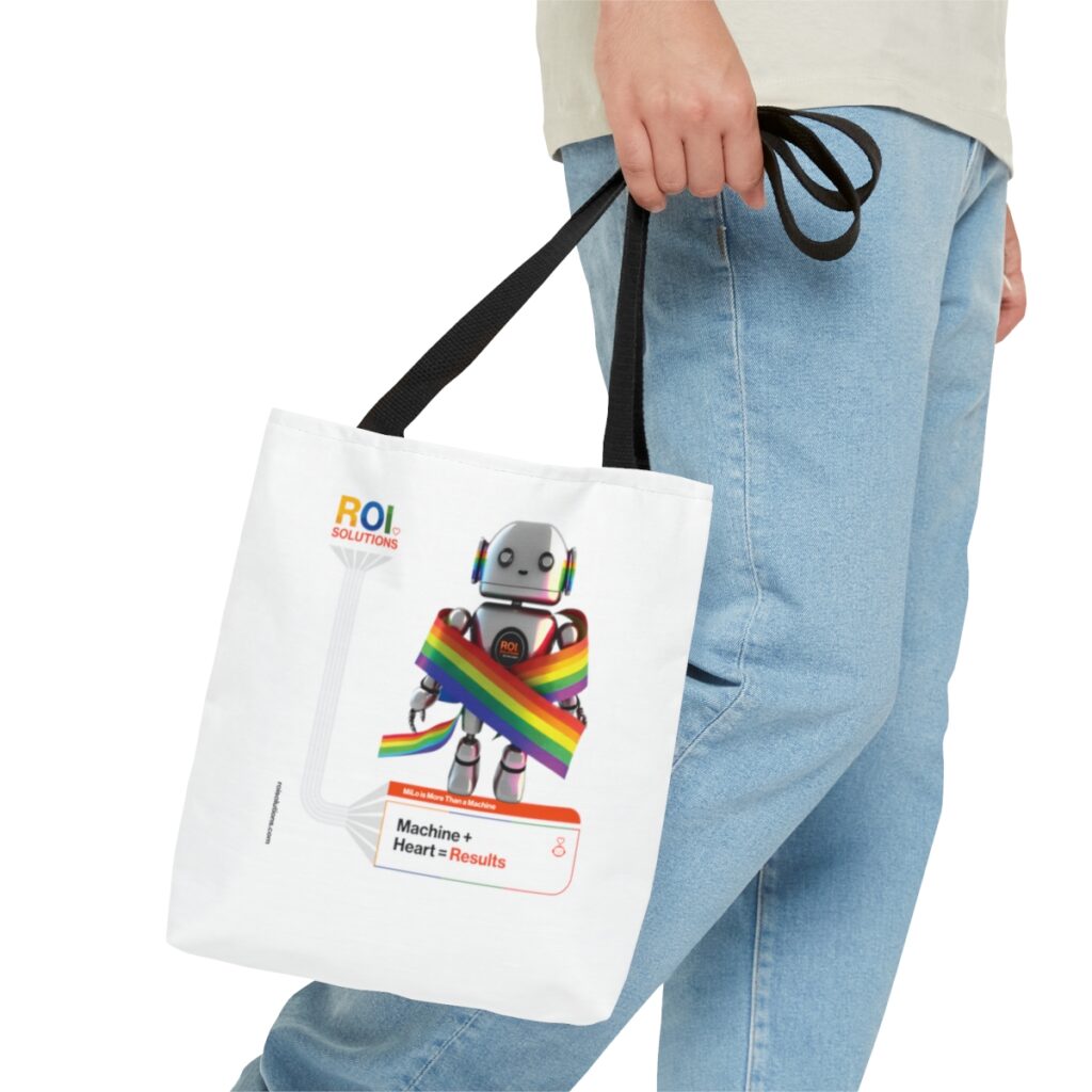 Close carry of the MiLo pride tote beside light jeans, the small logo printed at the top corner.