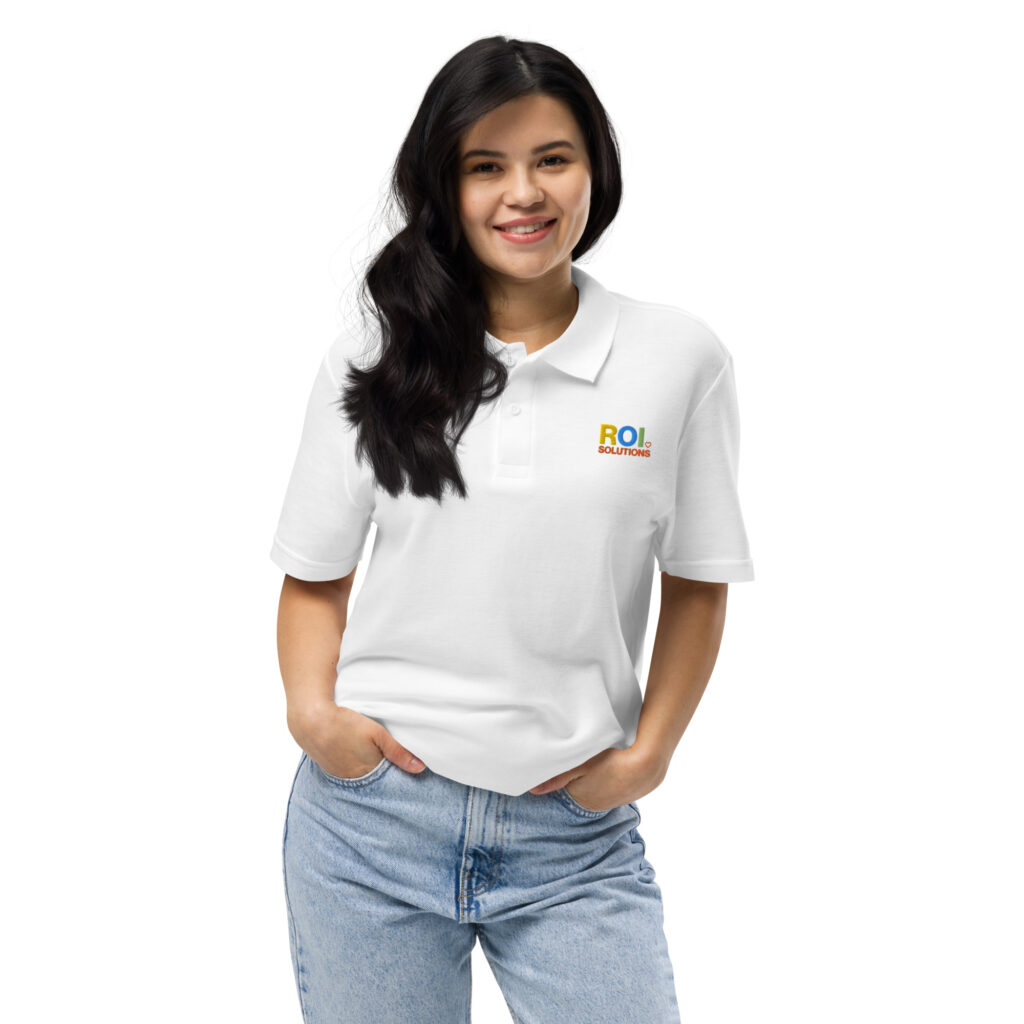 Smiling model in the white pique polo with the embroidered multicolor logo over light jeans.