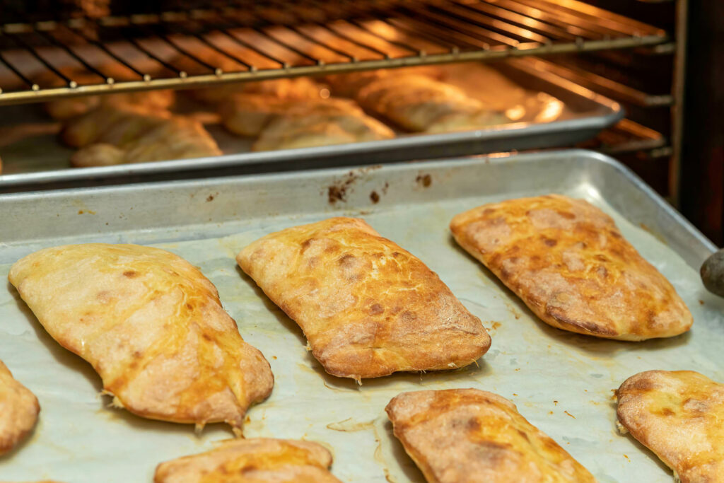 Golden filled pastry pockets on a parchment-lined tray at Butternut Bakehouse.