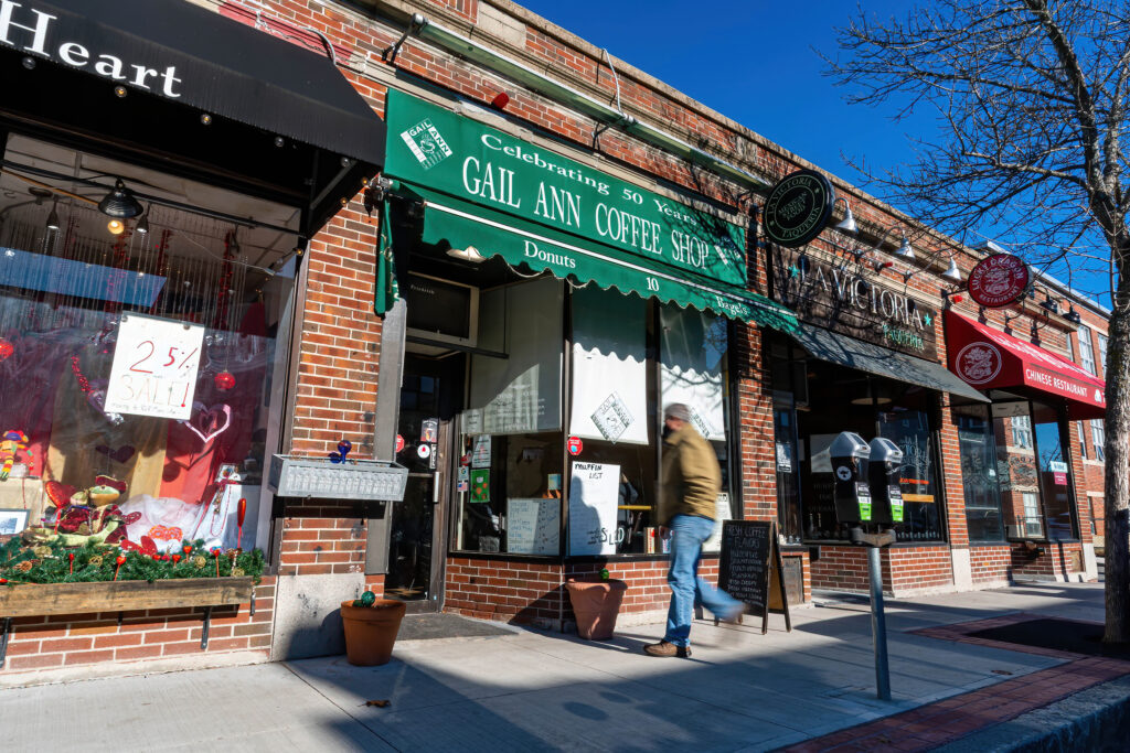 Gail Ann Coffee Shop green awning seen along the sidewalk on a sunny winter morning.