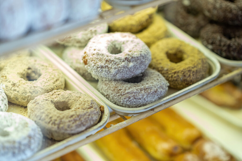 Powdered and glazed donuts in the display case at Gail Ann Coffee Shop.