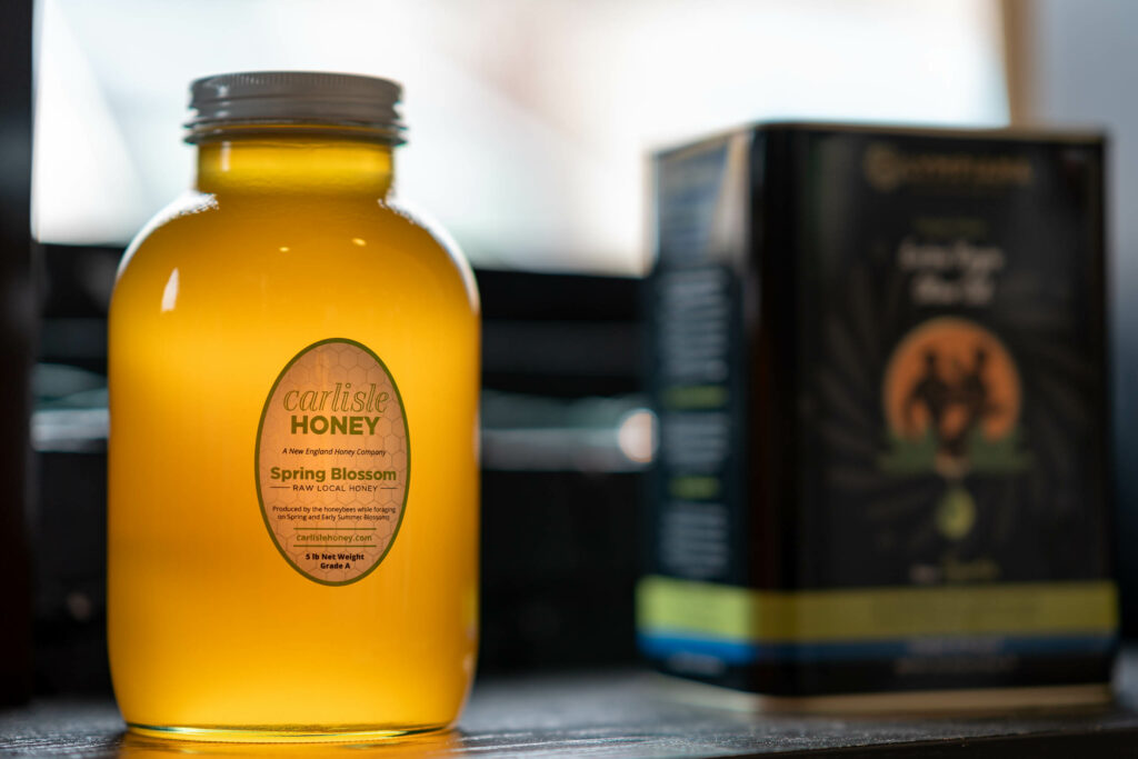 Jar of Carlisle Honey Spring Blossom raw local honey on the shelf at The Roasted Granola.